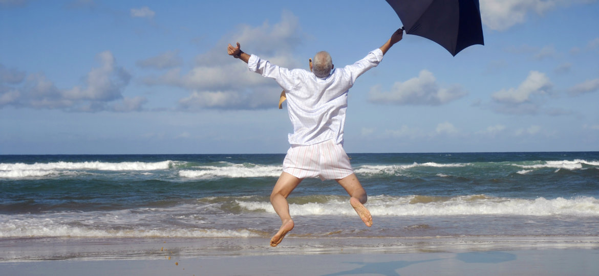 Happy businessman on a beautiful tropical beach