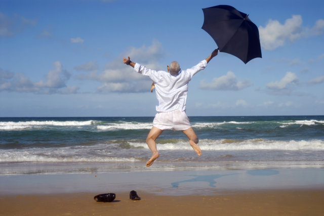 Happy businessman on a beautiful tropical beach